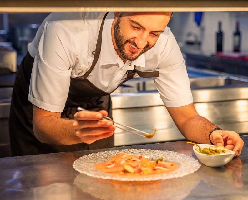 Chef Carlos Garcia checking a dish
